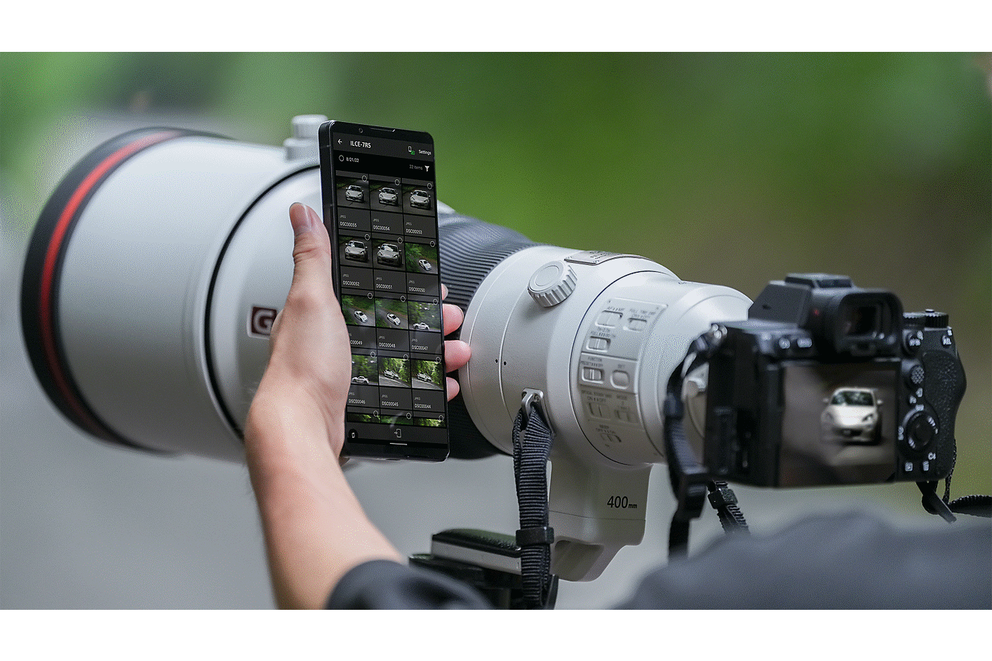 Image of a man operating his smartphone while shooting with the camera