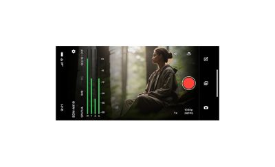 Smartphone recording app screen with green ECM-AX10 audio meters and a forest camera preview of a seated person.