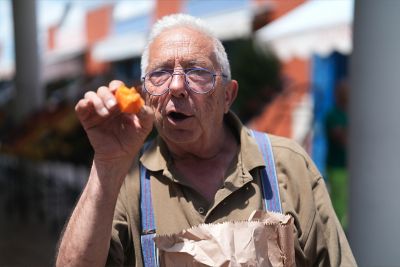 Image of an elderly man holding an orange object in ST (Standard) mode.