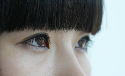 Image of a woman's face, with close-up focus on one eye