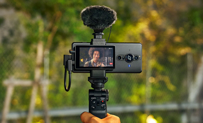 Người đàn ông đang tự quay hình mình với Màn hình vlog cho Xperia PRO-I, kết hợp với mic ngoài và báng tay cầm