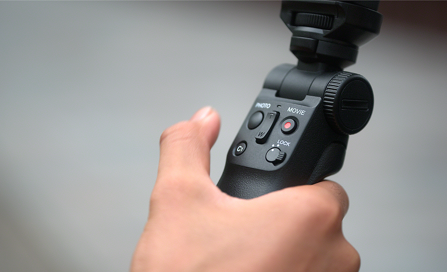 A Bluetooth shooting grip in someone's hand