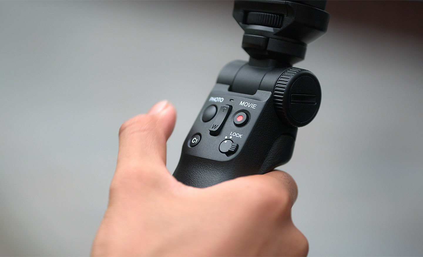 A Bluetooth shooting grip in someone's hand