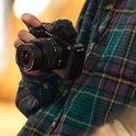 Image of a person holding a camera in their hand