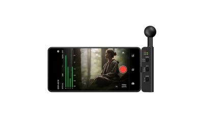 Horizontal smartphone displaying audio level meters and a forest video feed, with an ECM-AX10 microphone attached on the right.