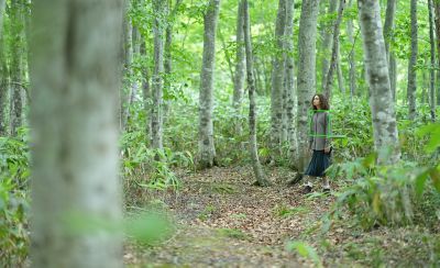 Image of a woman walking in the woods