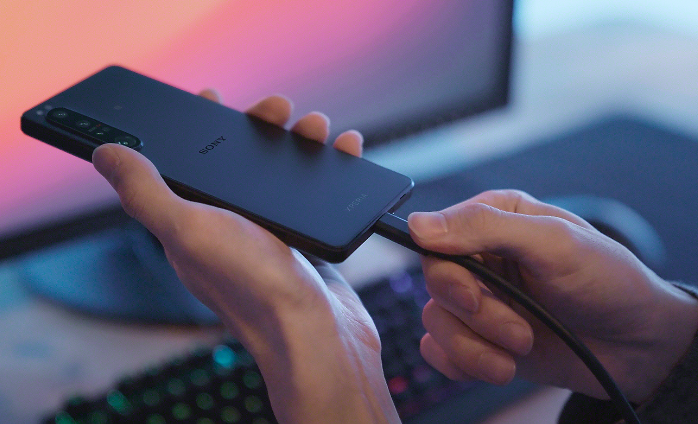 Close-up of someone plugging a cable into the Xperia 1 IV