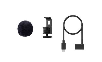 ECM-AX10 accessories: round fluffy windscreen on left, mounting clamp in center, coiled USB Type-C® cable on right.