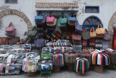 Image of colourful clothes and bags being sold by the roadside in NT (Neutral) mode.