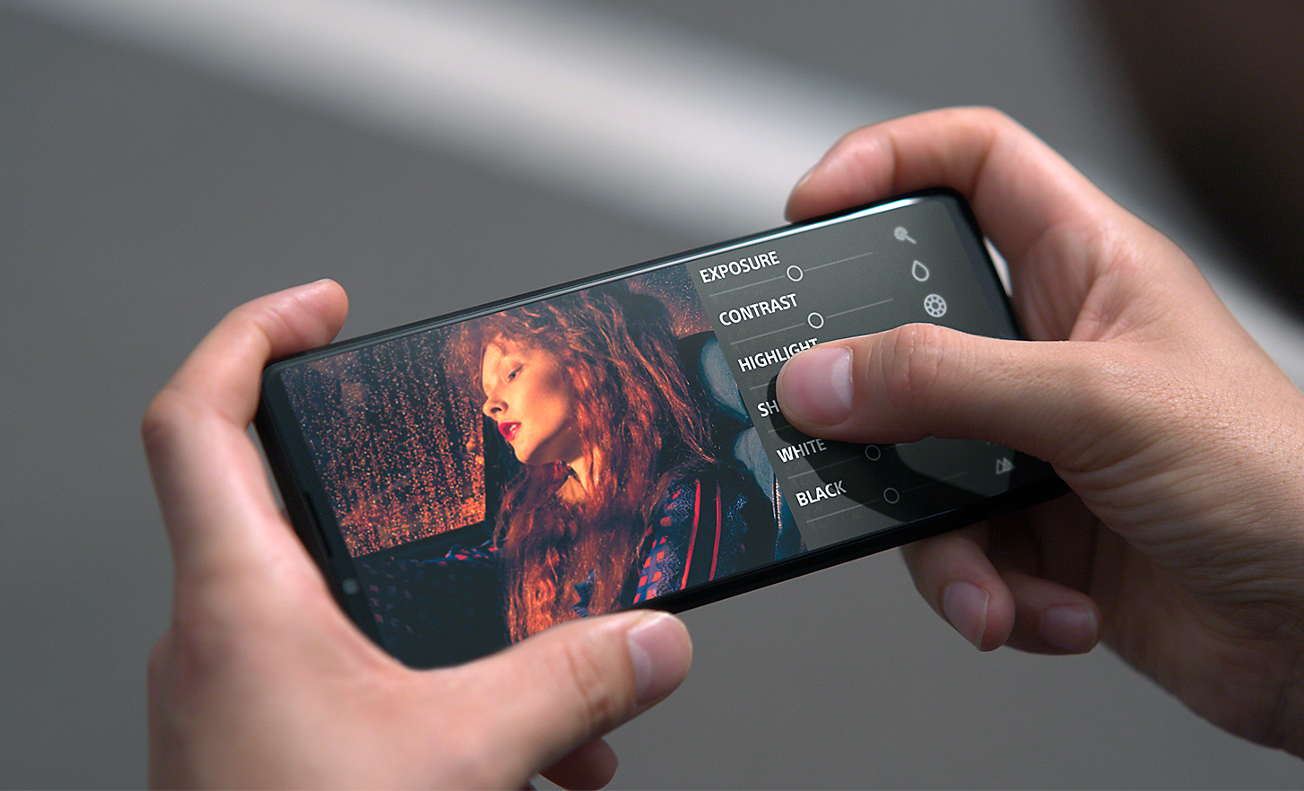 Hands tapping the UI on the Xperia PRO-I screen, which is displaying an image of a woman