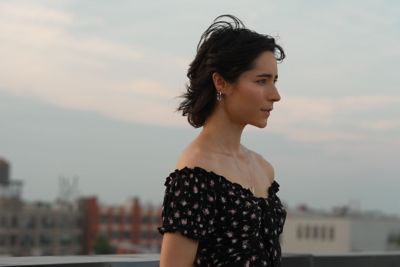 Image of a woman with a city background