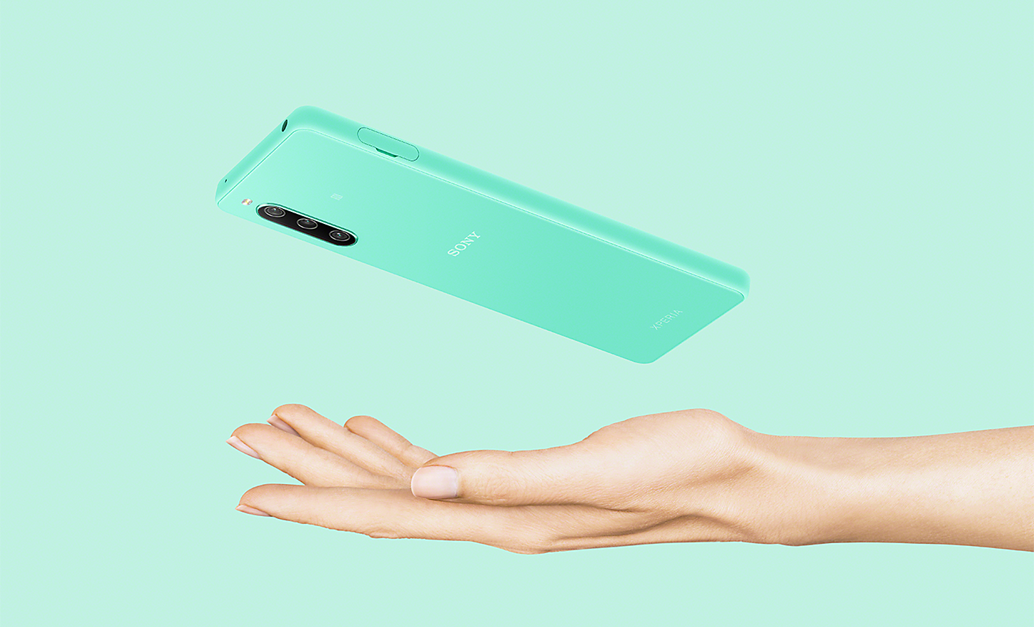 An Xperia 10 IV in mint above an outstretched hand
