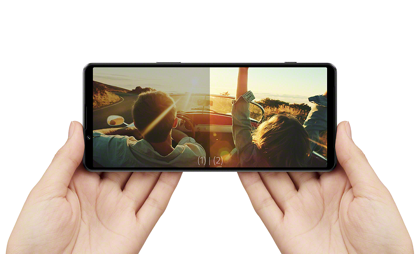 Hands holding Xperia 1 IV in landscape position to view content - the right half of the display is noticeably brighter than the left