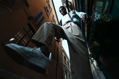 Image of a man from low angle raising a leg in FL (Film) mode.