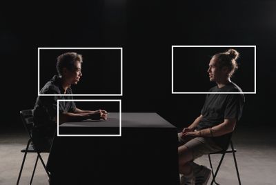 Image of two men talking face to face