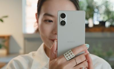 Close up image of a person taking a photo with an Xperia 5 V