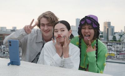 Image of an Xperia 5 V using the case stand to take a photo of three people on a roof top