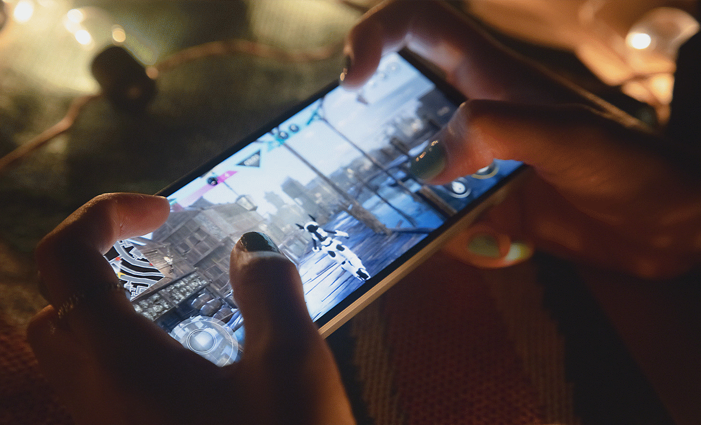 Close up image of a person playing a game with both hands on an Xperia 5 V