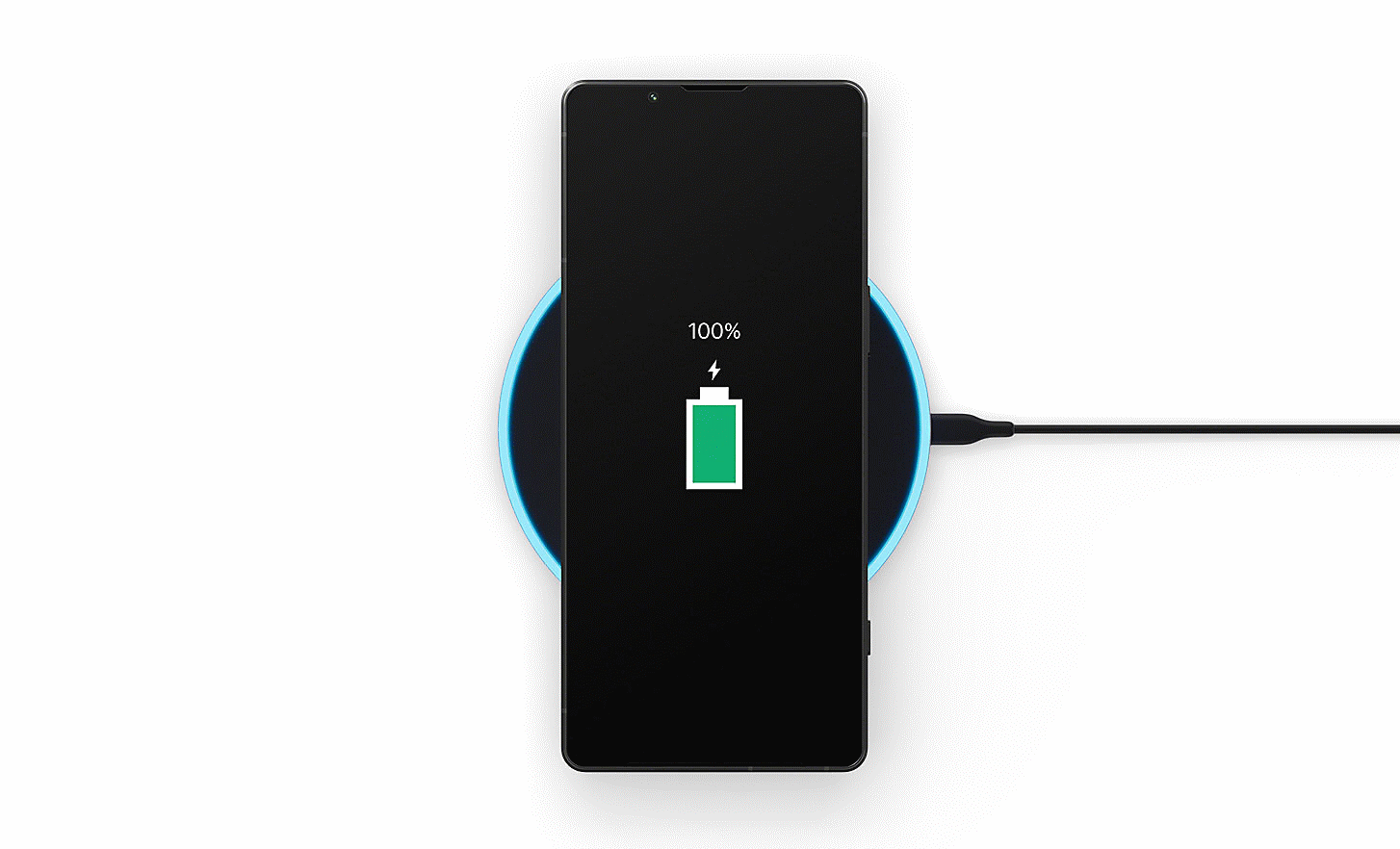 Image of an Xperia 5 V charging on a dock with a battery icon and 100% on the screen
