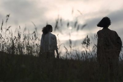 Image of two women walking in a field