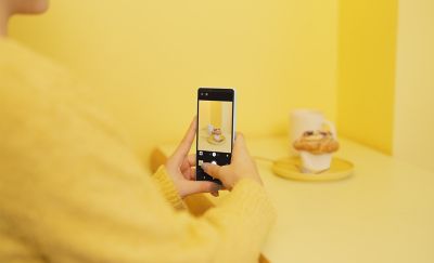 An Xperia 10 VI handset taking a photograph of a yellow object on a yellow background.