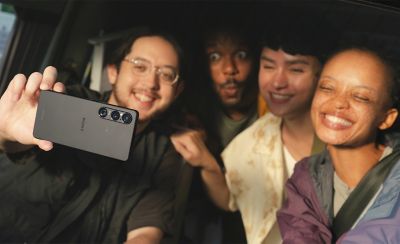 Four people taking a selfie.