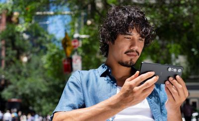 a person watching content on their phone while outdoors