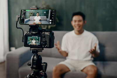 A live streamer using a Sony Alpha camera with an Xperia 1 V as an External monitor