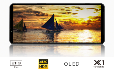 An Xperia 1V displaying a sailing boat at sunset and under it the logos for 21:9 Wide, 4K HDR, OLED, X1 for mobile