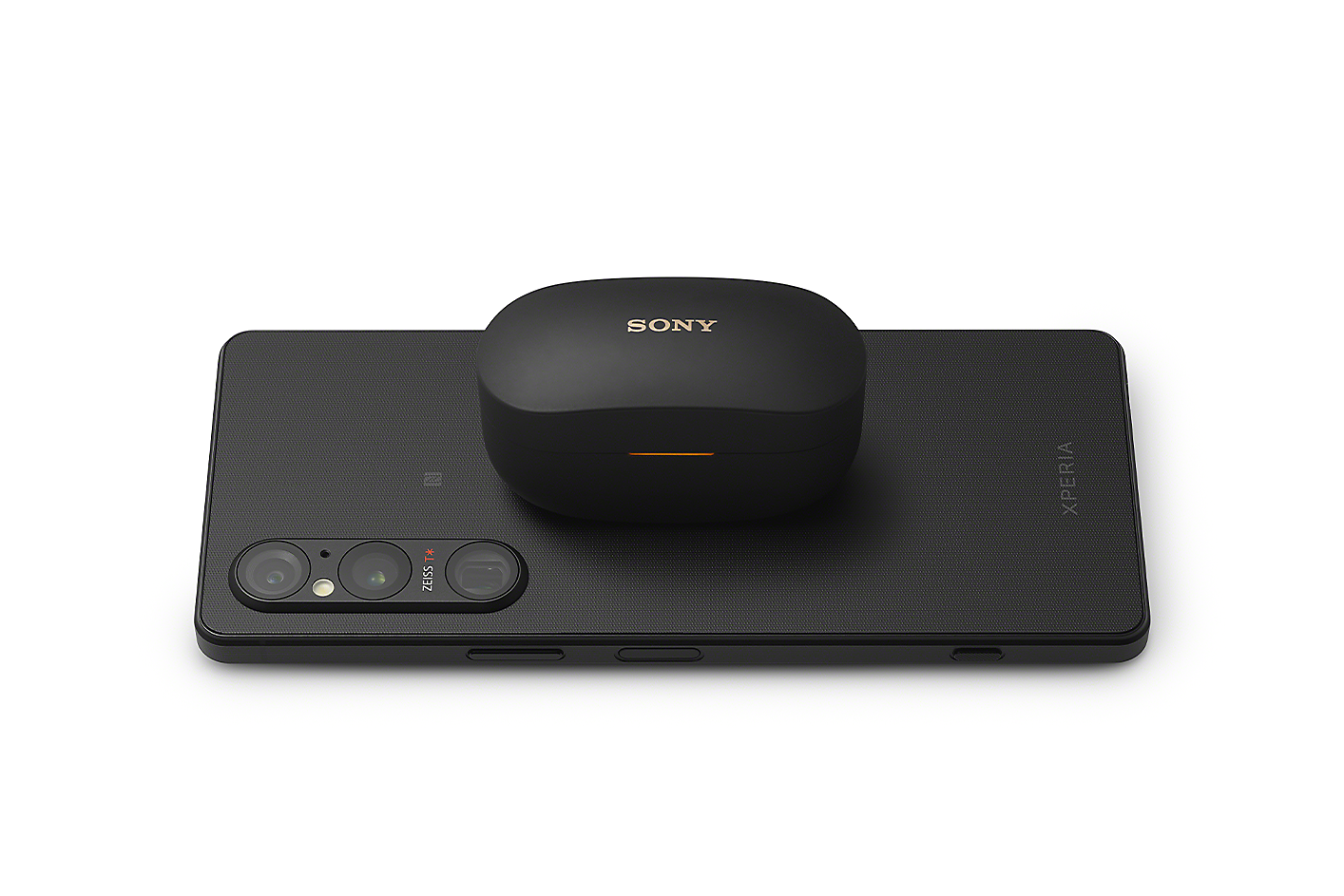 Xperia 1 V acting as a wireless charging pad for a wireless headphones charging case