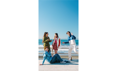 Ultra-wide angle shot of four friends by the sea