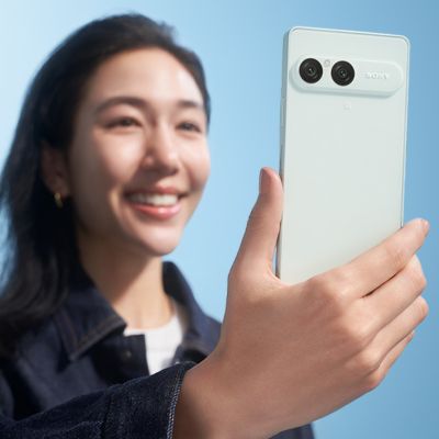 A person taking a selfie with the Frozen White Xperia 10 VIII smartphone
