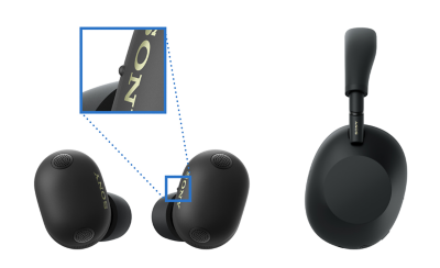 Hai tai nghe không dây màu đen ở bên cạnh tai nghe choàng tai màu đen, với ảnh phóng to làm nổi bật chấm xúc giác trên tai nghe bên trái