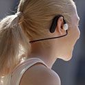 Image of a woman wearing Sony Float Run headphones shot from behind