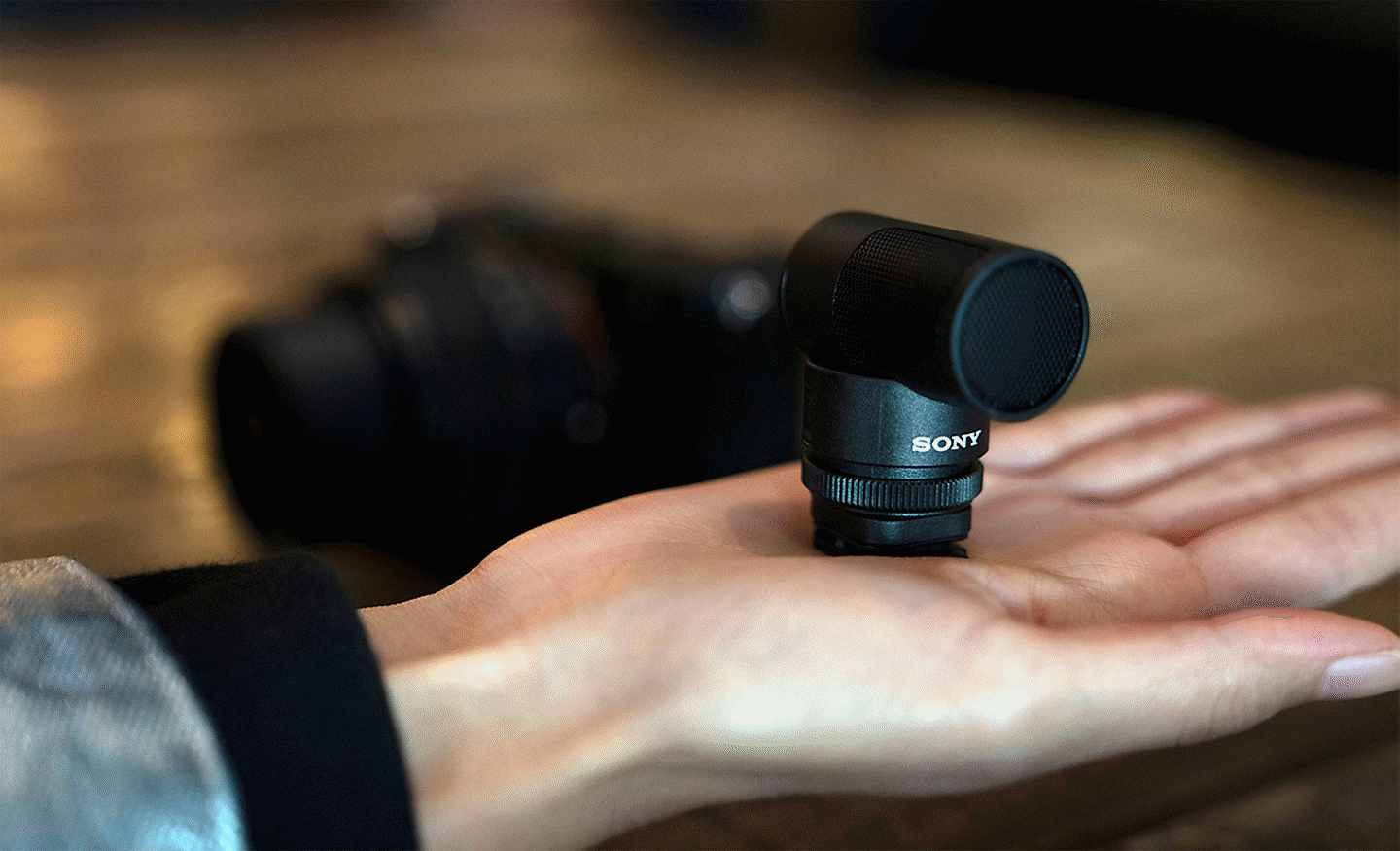 A photo of the ECM-G1 on the hand, compact enough to fit in one hand.