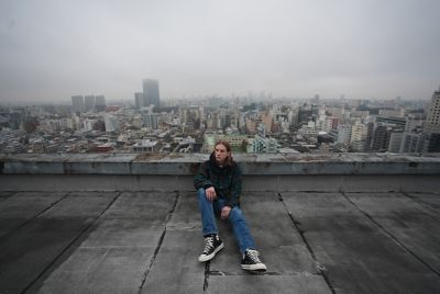 Image of a man sitting on a rooftop