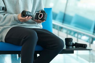 Image of a man exchanging a camera lens