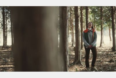 Image of a woman walking in the woods