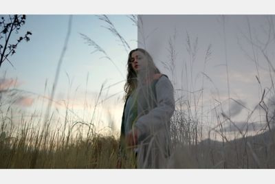 Image of a woman walking across a field