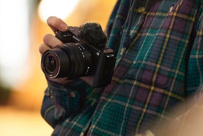 Image of a man holding a camera in his hand