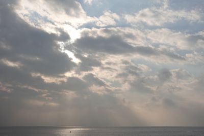 Sky with light pointing through a gap in the clouds.