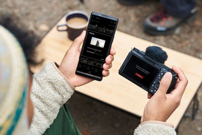 A person pairing a smartphone with a camera