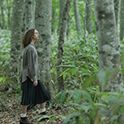 Image of a woman walking in the woods