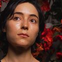 Image of a woman with flowers in the background