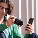 Imagen de un hombre transfiriendo datos de la cámara a un smartphone