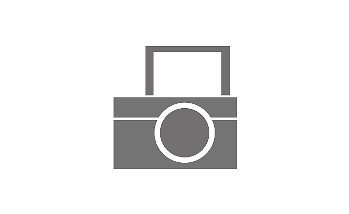 A grey icon of a camera with a flip screen.