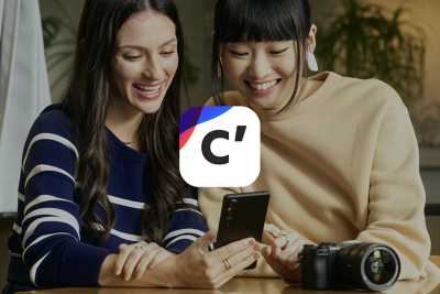 A photo of two women viewing images captured with a camera on the Creators' App for smartphones