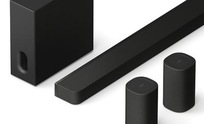 Close-up of a subwoofer, soundbar, and two rear speakers.