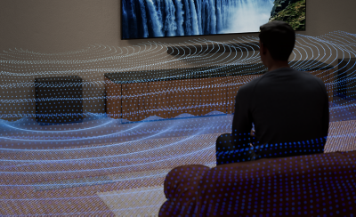 Person seated facing a TV, with a subwoofer and visualised sound waves spreading across the living room