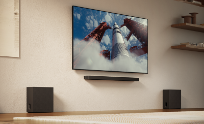 Salon avec un téléviseur, une barre de son et deux caissons de basses